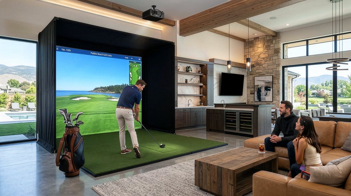 A man swings a golf club in a home simulator setup powered by an Optoma Golf Sim ZK521ST-B True 4K UHD Short Throw 5,000 Lumens Laser Projector, while a couple watches from a nearby sofa.