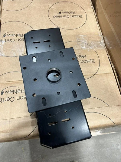 A square black metal General Purpose 8x8″ Adapter Plate with multiple mounting slots and a central circular opening, resting on a cardboard box.